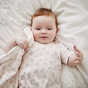 baby snuggling pink baby blanket