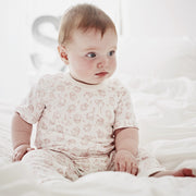 baby girl wearing shmuncki pink woodland baby grow