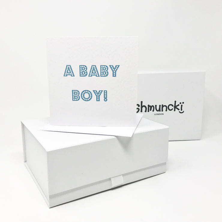 new baby by gift with card in blue font and shmuncki gift boxes
