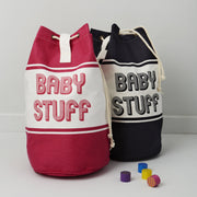 baby changing bag in blue or pink with baby stuff printed across the front